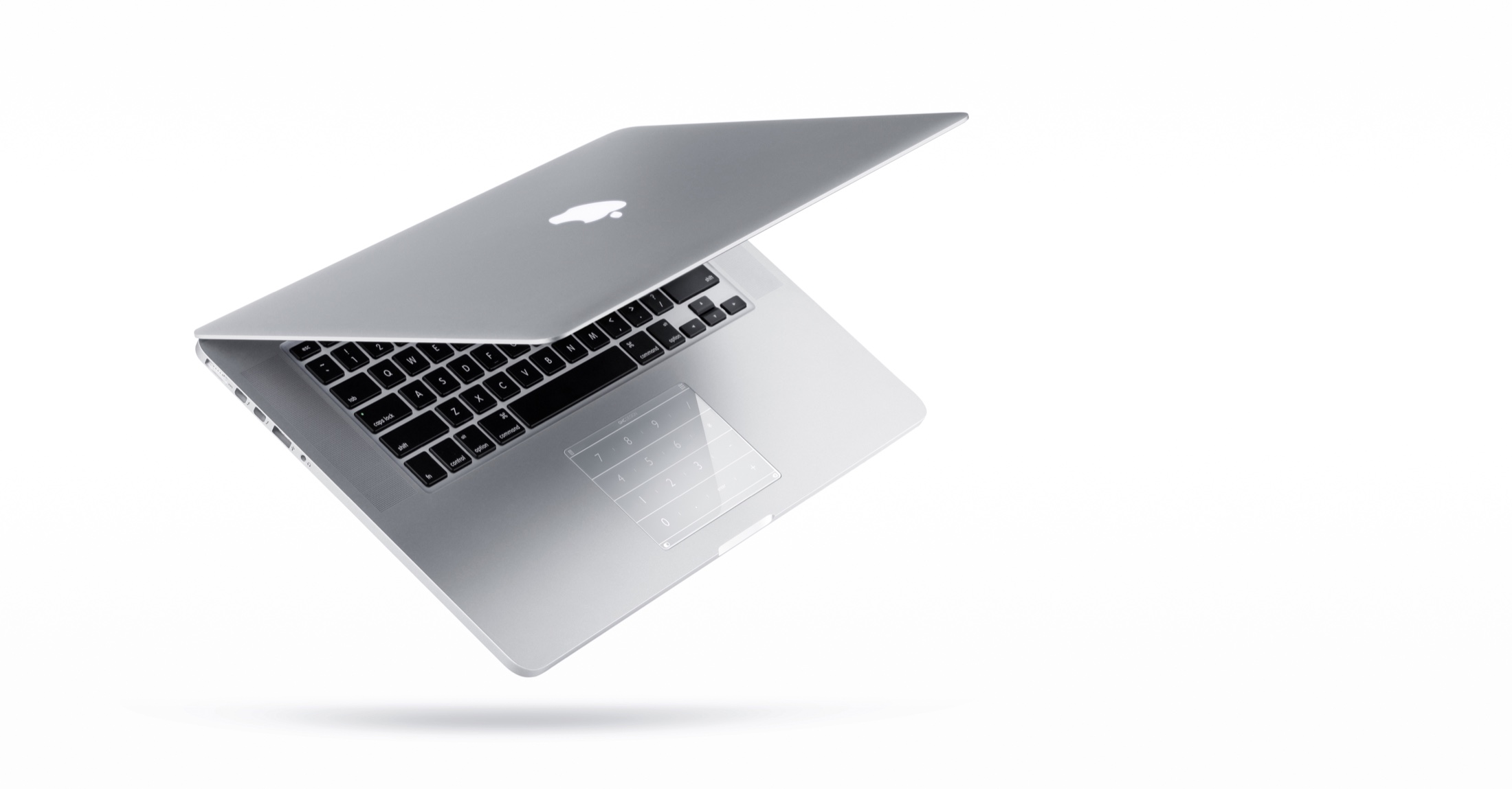 白い背景に浮かぶMacBookと、トラックパッドに貼られたNUMS